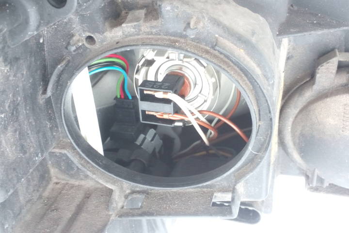 File:W220 left headlamp range adjustment motor via socket cover.jpg