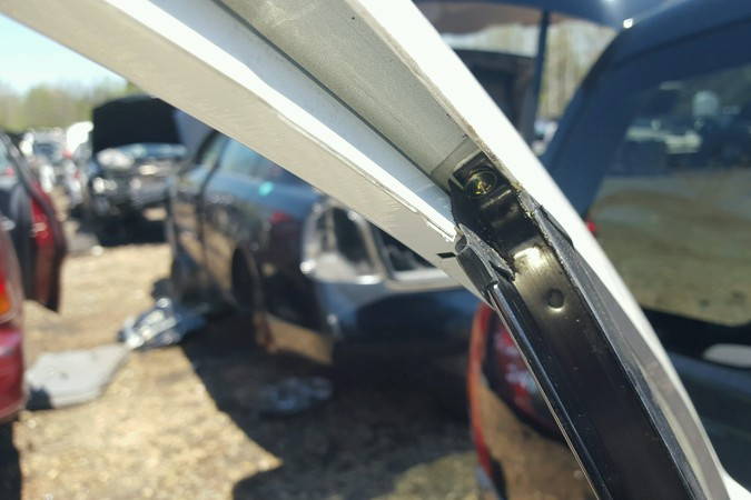 File:W220 screw holding rear window stay.jpg