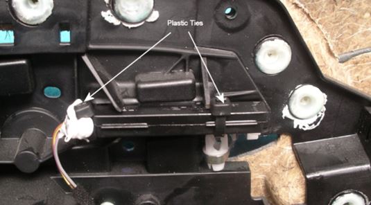 File:Repaired Illumination Module in Door Panel Showing Plastic Ties and White Silicon Adhesive.JPG