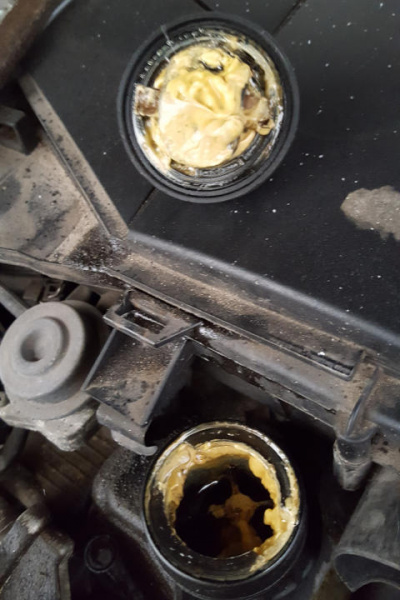 File:W220 engine oil cap milky water residue.jpg